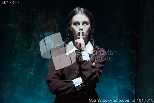 Image of Portrait of a young girl in school uniform as killer woman