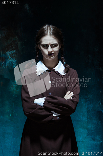 Image of Portrait of a young girl in school uniform as killer woman