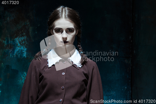 Image of Portrait of a young girl in school uniform as killer woman