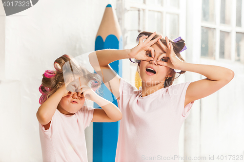 Image of Little girl playing with her mother