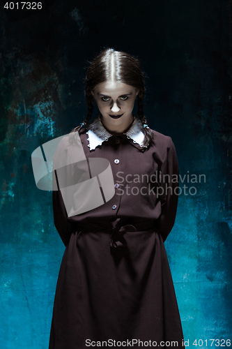 Image of Portrait of a young girl in school uniform as killer woman