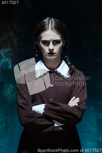 Image of Portrait of a young girl in school uniform as killer woman