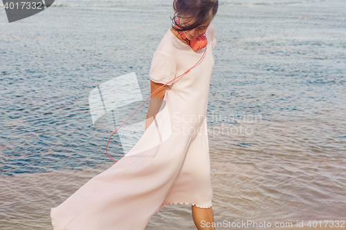 Image of Woman walking on the beach