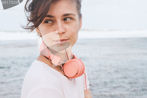 Image of Woman walking on the beach