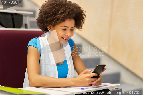 Image of african student girl with smartphone on lecture