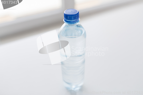 Image of close up of bottle with drinking water on table