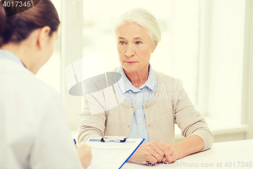 Image of doctor with clipboard and senior woman at hospital