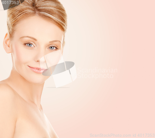 Image of beautiful young woman face over beige background
