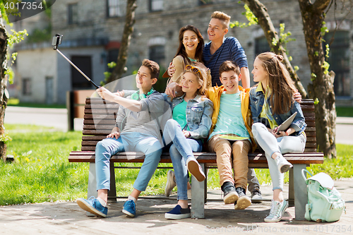 Image of happy teenage students taking selfie by smartphone