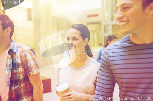 Image of group of smiling students with paper coffee cups