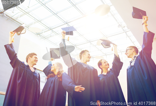 Image of group of happy students in mortarboards at school