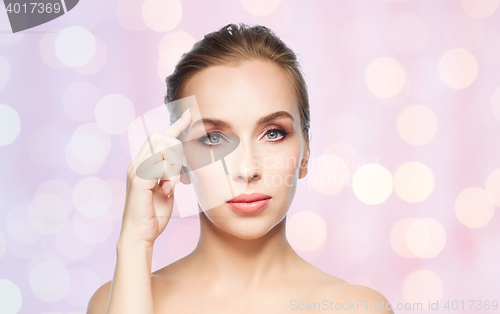 Image of beautiful young woman showing her forehead