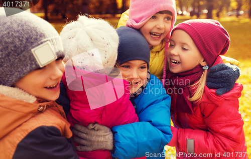 Image of group of happy children hugging in autumn park