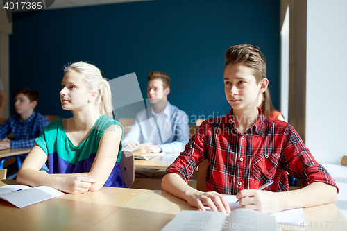 Image of group of students with books at school lesson