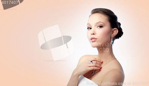 Image of beautiful woman with earring, ring and pendant