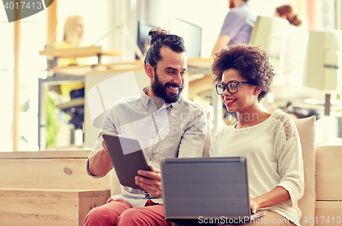 Image of creative team with laptop and tablet pc in office