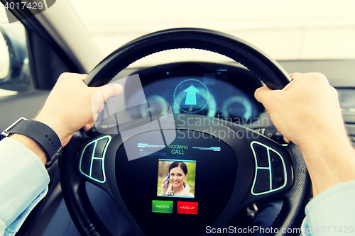 Image of close up of man driving car with incoming call