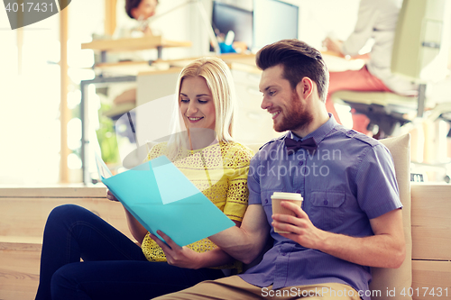 Image of office workers with folder and coffee