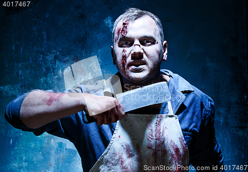 Image of Bloody Halloween theme: crazy killer as butcher with a knife