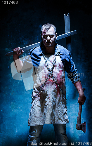 Image of Bloody Halloween theme: crazy killer as butcher with an ax