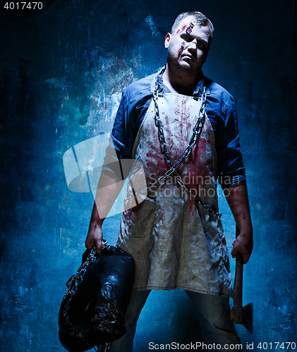 Image of Bloody Halloween theme: crazy killer as butcher with an ax