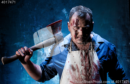 Image of Bloody Halloween theme: crazy killer as butcher with an ax