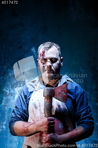 Image of Bloody Halloween theme: crazy killer as butcher with an ax