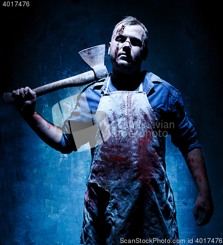 Image of Bloody Halloween theme: crazy killer as butcher with an ax