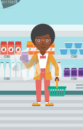 Image of Customer with shopping basket and tube of cream.