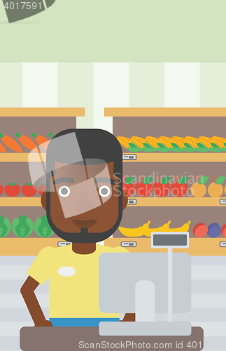 Image of Cashier standing at the checkout in supermarket.