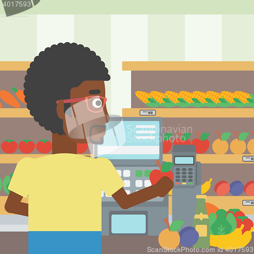 Image of Cashier standing at the checkout in supermarket.