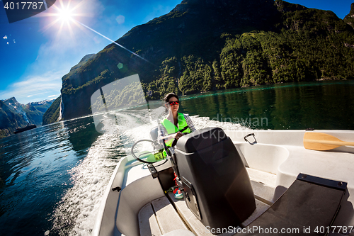 Image of Woman driving a motor boat