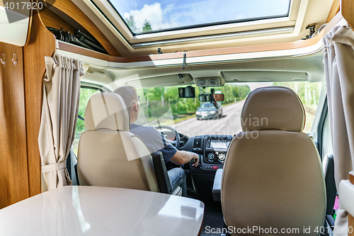 Image of Man driving on a road in the Camper Van