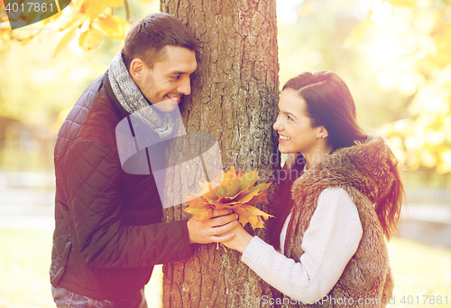 Image of romantic couple playing in the autumn park