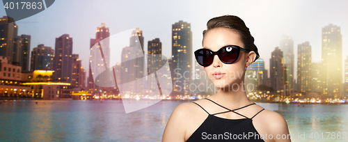 Image of beautiful young woman in elegant black sunglasses