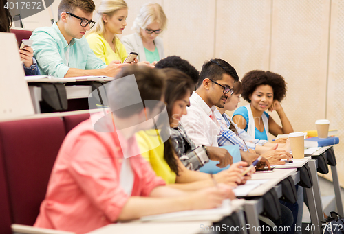 Image of group of students with coffee writing on lecture