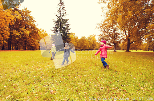 Image of happy little children running and playing outdoors