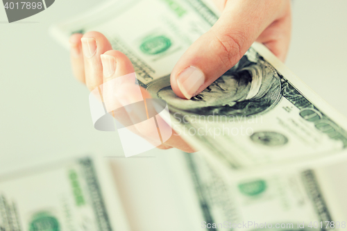 Image of close up of woman hand counting us dollar money