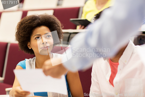 Image of teacher giving test to student girl on lecture