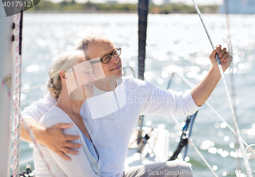 Image of senior couple hugging on sail boat or yacht in sea