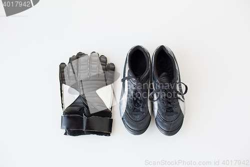 Image of close up of goalkeeper gloves and football boots