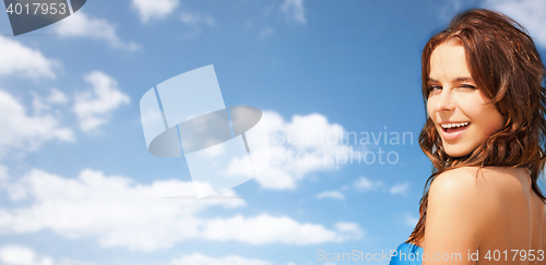 Image of happy beautiful woman over blue sky and clouds