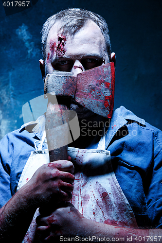 Image of Bloody Halloween theme: crazy killer as butcher with an ax