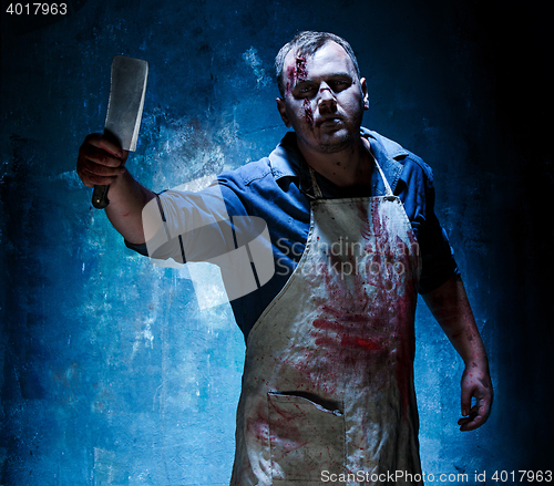 Image of Bloody Halloween theme: crazy killer as butcher with a knife