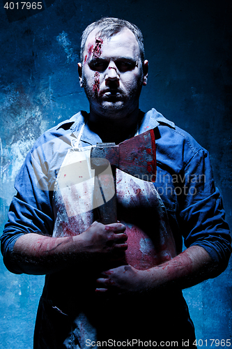 Image of Bloody Halloween theme: crazy killer as butcher with an ax