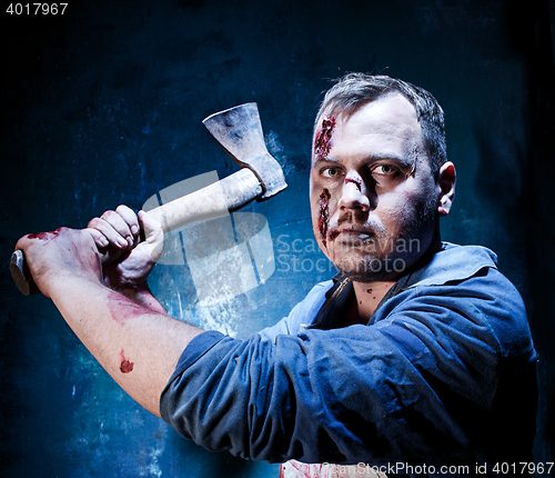 Image of Bloody Halloween theme: crazy killer as butcher with an ax