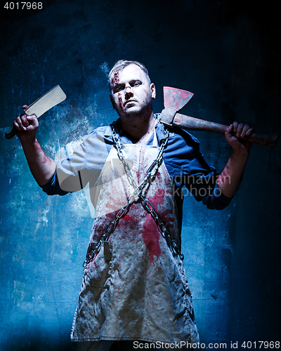 Image of Bloody Halloween theme: crazy killer as butcher with an ax