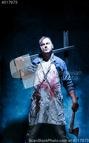 Image of Bloody Halloween theme: crazy killer as butcher with an ax