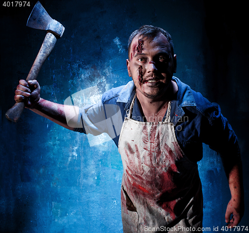 Image of Bloody Halloween theme: crazy killer as butcher with an ax