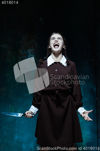 Image of Portrait of a young girl in school uniform as killer woman